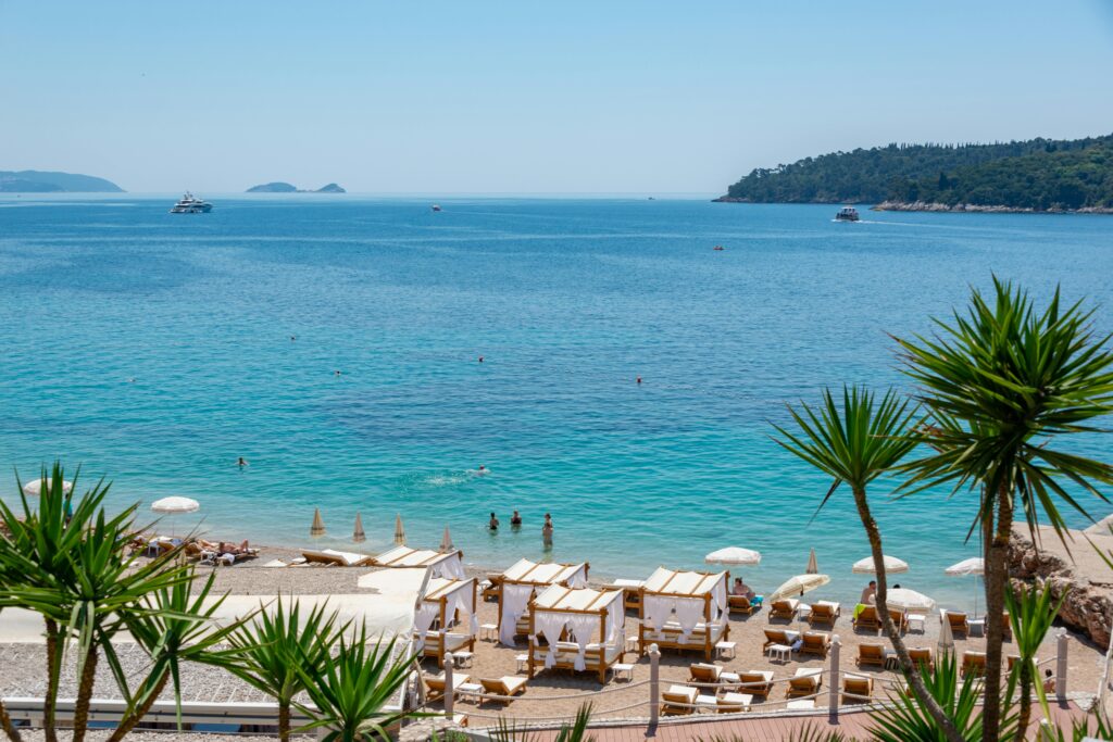 Stunning beachfront with clear blue waters and loungers in Dubrovnik, Croatia.